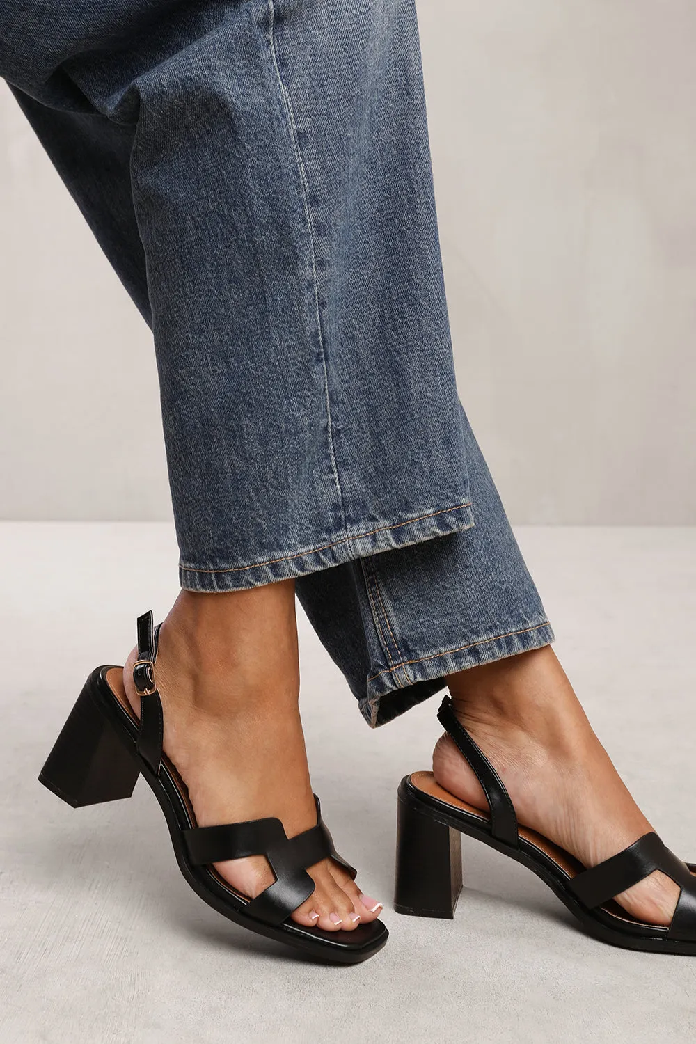 SORAYA STRAPPY SANDALS WITH BLOCK HEEL IN BLACK FAUX LEATHER